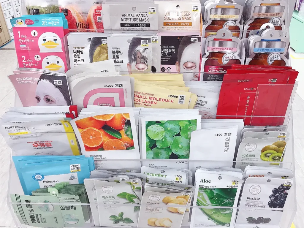 A tiered acrylic display stand packed with colorful individual face mask sheets starting from 500 KRW