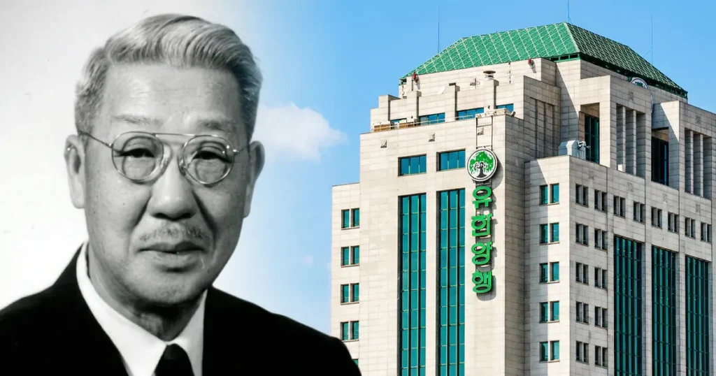 Portrait of Dr. New Il-han in glasses and a suit next to the modern stone and glass headquarters of Yuhan Corporation.